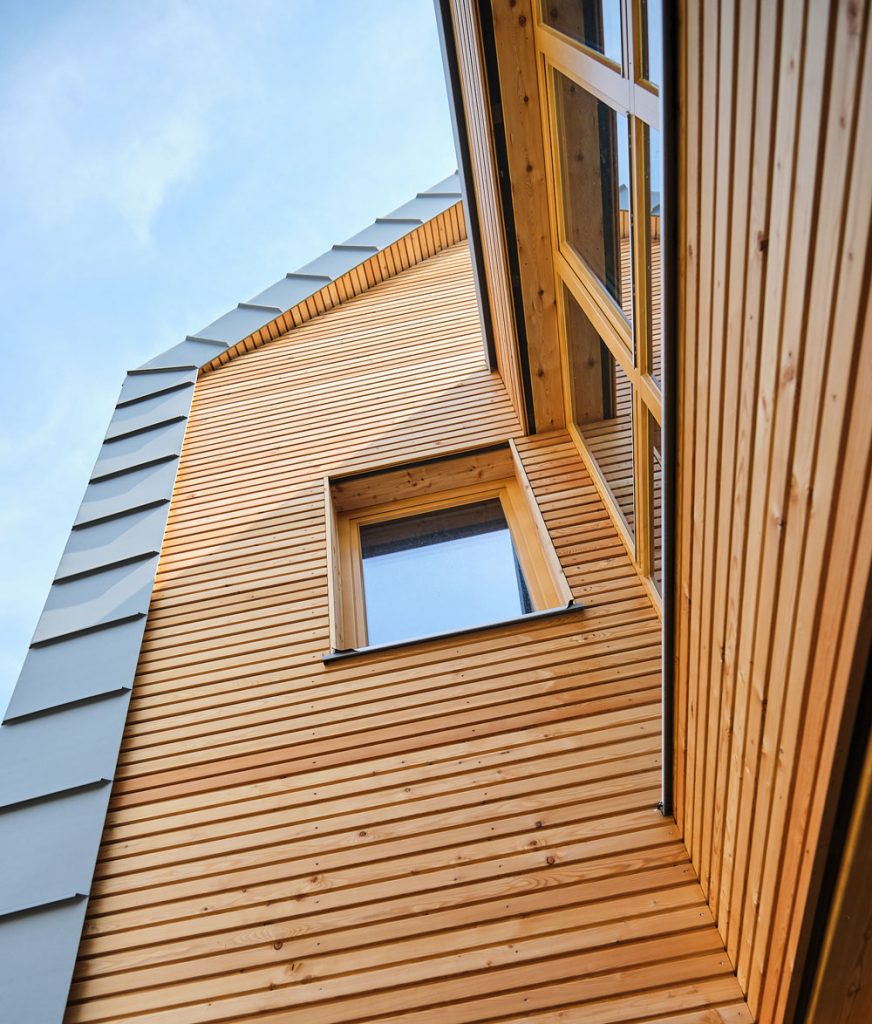 Detailansicht der Holzfassade von Haus Fünf mit Fenster einer Wohneinheit.